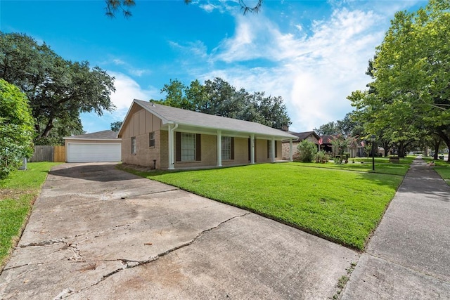 9314 Kristin Dr, Houston, TX 77031 - ranch-style house featuring a front lawn, brick siding, board and batten siding, and a detached garage