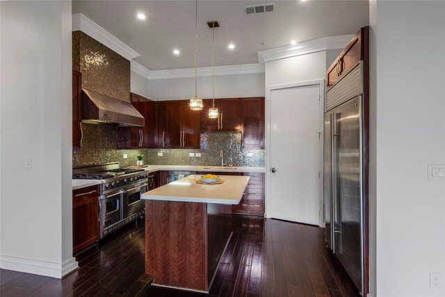 3388 Sage Rd Unit 1702, Houston, TX 77056 - kitchen featuring high end appliances, wall chimney range hood, light countertops, dark wood-style flooring, and a sink