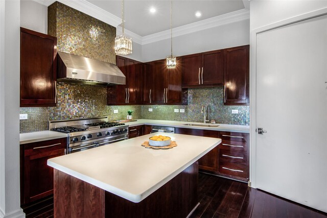 3388 Sage Rd Unit 1702, Houston, TX 77056 - kitchen with a sink, stainless steel appliances, wall chimney range hood, light countertops, and crown molding