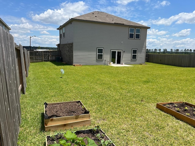 21596 Rolling Streams Dr, New Caney, TX 77357 - back of property featuring a vegetable garden and central AC unit
