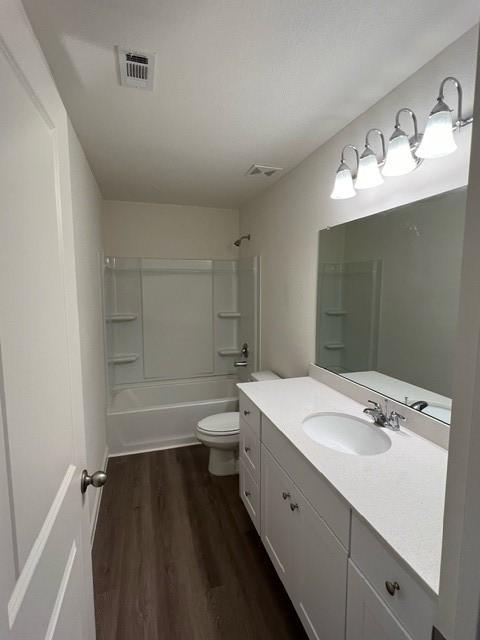 21596 Rolling Streams Dr, New Caney, TX 77357 - full bathroom featuring wood finished floors, toilet, vanity, and washtub / shower combination
