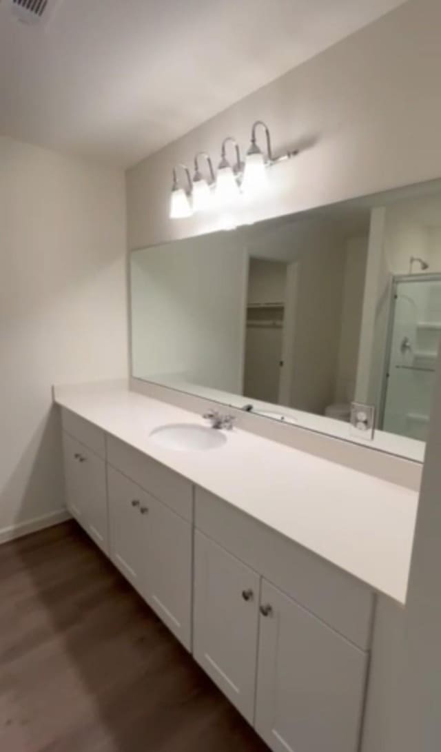 21596 Rolling Streams Dr, New Caney, TX 77357 - bathroom featuring wood finished floors, vanity, and baseboards
