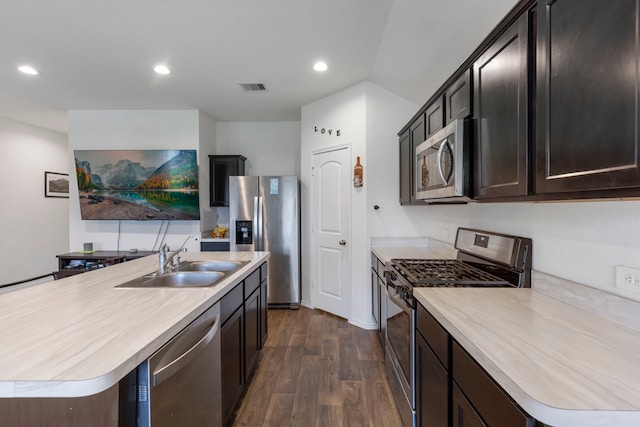 21623 Oakwood Meadows Ln, Katy, TX 77449 - kitchen with stainless steel appliances, a sink, light countertops, dark wood-style floors, and recessed lighting