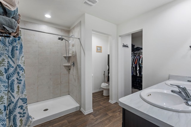 21623 Oakwood Meadows Ln, Katy, TX 77449 - bathroom featuring a stall shower, toilet, wood finished floors, baseboards, and double vanity