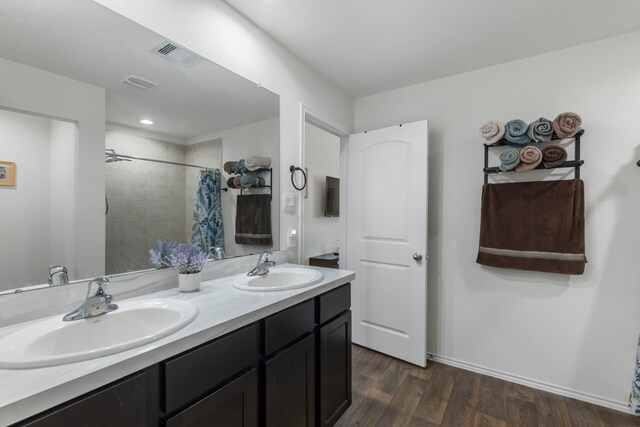 21623 Oakwood Meadows Ln, Katy, TX 77449 - full bath featuring wood finished floors, a tile shower, double vanity, and baseboards