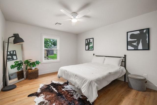 2114 Lazybrook Dr, Houston, TX 77008 - bedroom with wood finished floors, baseboards, and ceiling fan