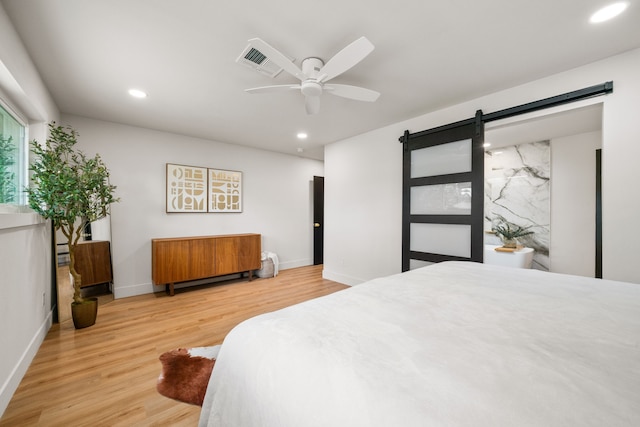 2114 Lazybrook Dr, Houston, TX 77008 - bedroom featuring a barn door, wood finished floors, recessed lighting, baseboards, and ceiling fan