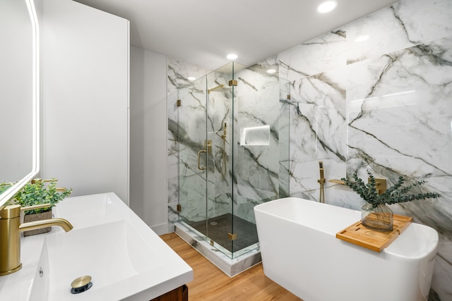 2114 Lazybrook Dr, Houston, TX 77008 - full bath featuring a marble finish shower, a freestanding bath, vanity, wood finished floors, and recessed lighting