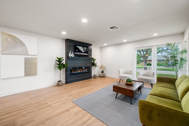2114 Lazybrook Dr, Houston, TX 77008 - living room with wood finished floors, baseboards, a large fireplace, and recessed lighting