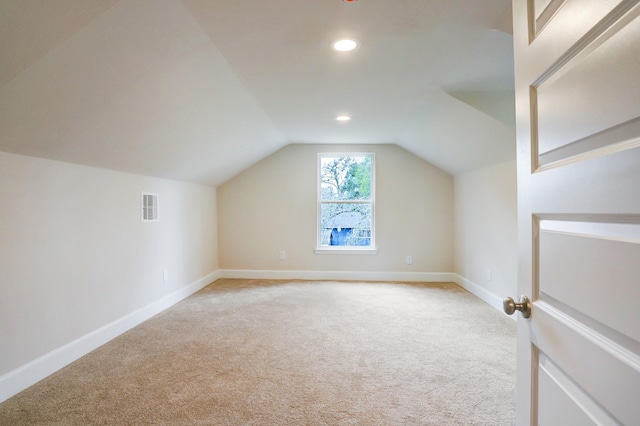 813 Nelson St, Sealy, TX 77474 - additional living space with light colored carpet, vaulted ceiling, baseboards, and recessed lighting