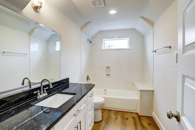 813 Nelson St, Sealy, TX 77474 - bathroom with vanity, toilet, vaulted ceiling, wood finished floors, and tub / shower combination