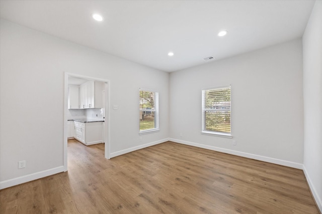 813 Nelson St, Sealy, TX 77474 - empty room with light wood-type flooring, baseboards, and recessed lighting