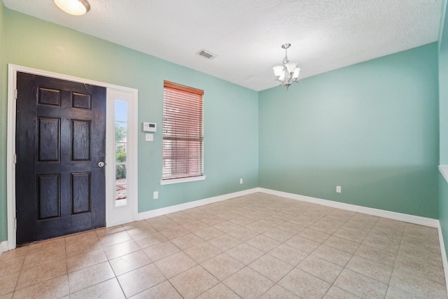 3339 Legends Creek Dr, Spring, TX 77386 - tiled foyer entrance featuring a chandelier, baseboards, and a textured ceiling