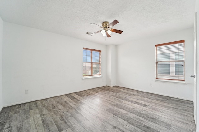 3339 Legends Creek Dr, Spring, TX 77386 - unfurnished room with a ceiling fan, wood finished floors, a textured ceiling, and baseboards