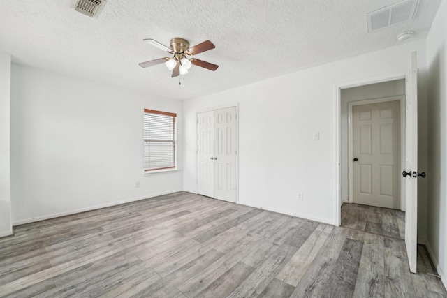 3339 Legends Creek Dr, Spring, TX 77386 - spare room featuring wood finished floors, ceiling fan, a textured ceiling, and a smoke detector