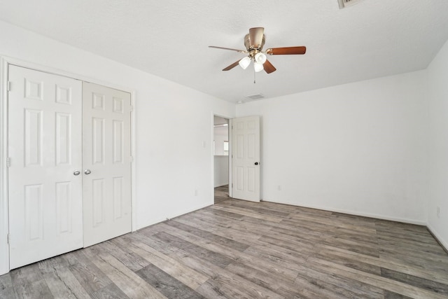 3339 Legends Creek Dr, Spring, TX 77386 - unfurnished bedroom featuring wood finished floors, a closet, and ceiling fan
