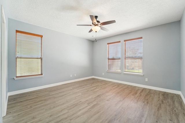 3339 Legends Creek Dr, Spring, TX 77386 - unfurnished room featuring ceiling fan, wood finished floors, a textured ceiling, and baseboards