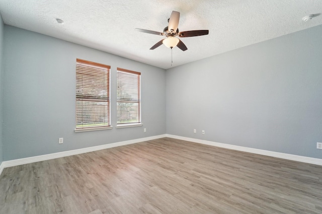 3339 Legends Creek Dr, Spring, TX 77386 - empty room with a ceiling fan, wood finished floors, a textured ceiling, baseboards, and a smoke detector
