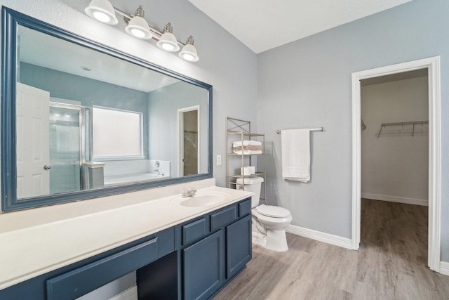 3339 Legends Creek Dr, Spring, TX 77386 - full bathroom featuring wood finished floors, a stall shower, toilet, vanity, and baseboards