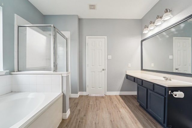 3339 Legends Creek Dr, Spring, TX 77386 - full bath featuring wood finished floors, a shower stall, a bath, vanity, and baseboards
