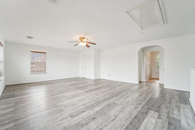 3339 Legends Creek Dr, Spring, TX 77386 - unfurnished room with attic access, light wood-style floors, a ceiling fan, and arched walkways