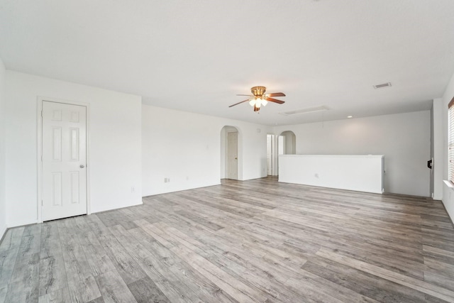 3339 Legends Creek Dr, Spring, TX 77386 - unfurnished living room featuring wood finished floors, ceiling fan, and arched walkways