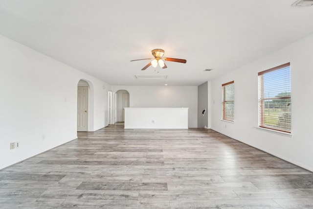 3339 Legends Creek Dr, Spring, TX 77386 - unfurnished room featuring ceiling fan, light wood-style floors, and arched walkways
