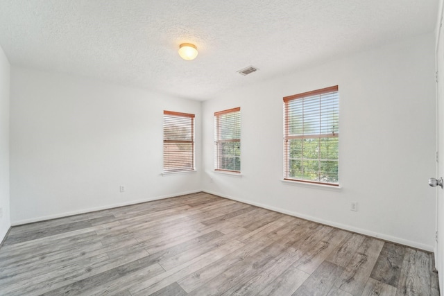 3339 Legends Creek Dr, Spring, TX 77386 - spare room with wood finished floors, a textured ceiling, and baseboards