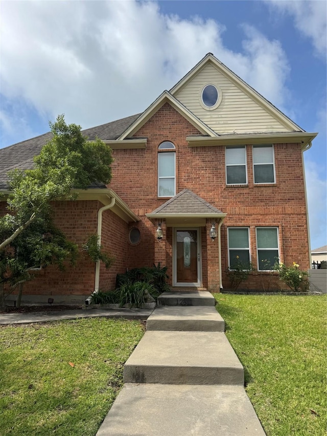 12811 E Conquistador Dr, Galveston, TX 77554 - view of front of house featuring a front yard and brick siding