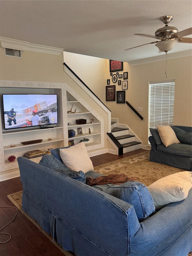 12811 E Conquistador Dr, Galveston, TX 77554 - living room featuring wood finished floors, a ceiling fan, crown molding, stairs, and a textured ceiling
