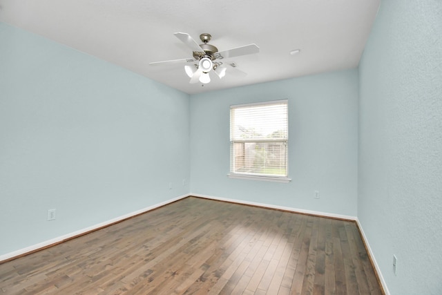 6007 Indian Crk, Missouri City, TX 77459 - unfurnished room featuring baseboards, hardwood / wood-style flooring, and ceiling fan