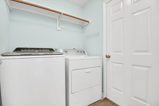 6007 Indian Crk, Missouri City, TX 77459 - laundry room with independent washer and dryer and light wood-style floors