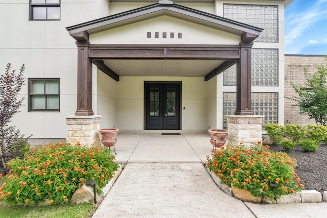 19727 Country Lake Dr, Magnolia, TX 77355 - view of exterior entry featuring stucco siding and french doors