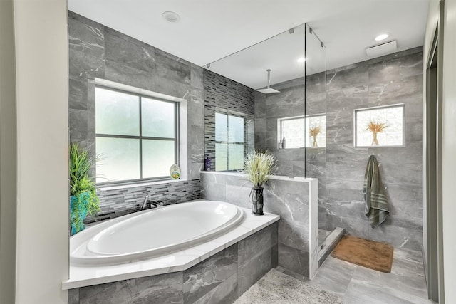 19727 Country Lake Dr, Magnolia, TX 77355 - full bath with a garden tub, tiled shower, tile walls, and plenty of natural light
