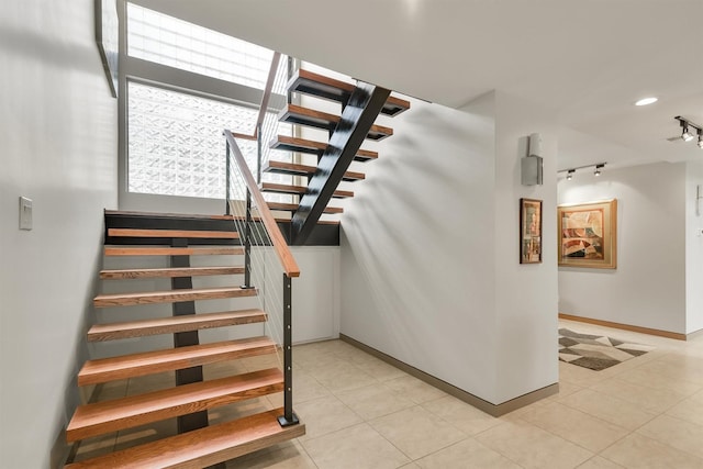 19727 Country Lake Dr, Magnolia, TX 77355 - stairs featuring track lighting, baseboards, and tile patterned flooring