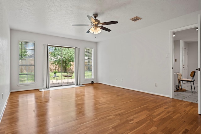 10255 Crooks Way Ct, Houston, TX 77065 - empty room featuring ceiling fan, wood finished floors, baseboards, and a textured ceiling