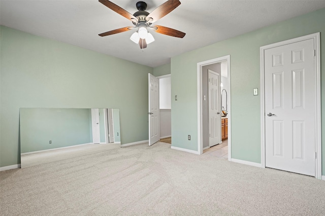 10255 Crooks Way Ct, Houston, TX 77065 - unfurnished bedroom featuring light colored carpet, baseboards, ensuite bathroom, and ceiling fan