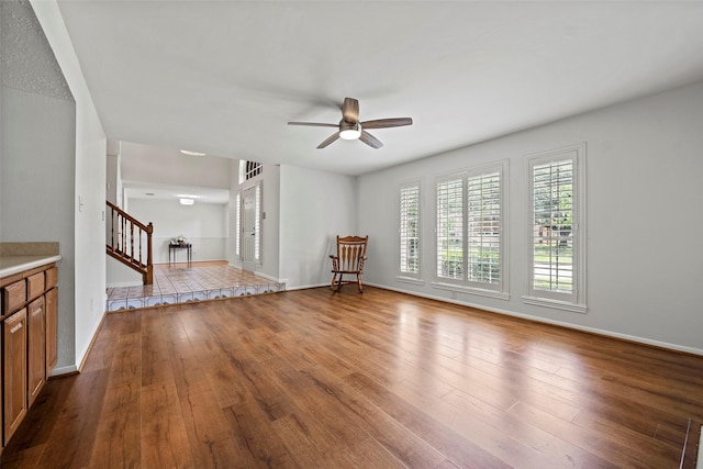 10255 Crooks Way Ct, Houston, TX 77065 - unfurnished living room with stairway, a ceiling fan, wood finished floors, and baseboards