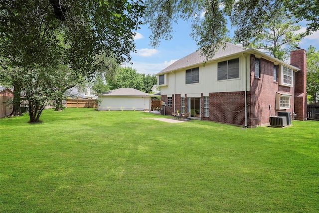 10255 Crooks Way Ct, Houston, TX 77065 - back of property featuring brick siding, a chimney, a patio, a shingled roof, and cooling unit