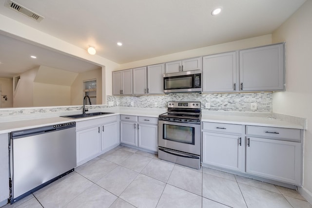 19314 Cactus Thorn Dr, Cypress, TX 77433 - kitchen featuring appliances with stainless steel finishes, a sink, backsplash, gray cabinets, and recessed lighting