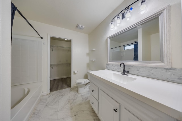 19314 Cactus Thorn Dr, Cypress, TX 77433 - bathroom with marble finish floors, toilet, vanity, a spacious closet, and tasteful backsplash