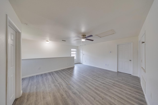 19314 Cactus Thorn Dr, Cypress, TX 77433 - unfurnished room featuring wood finished floors, baseboards, a ceiling fan, and attic access