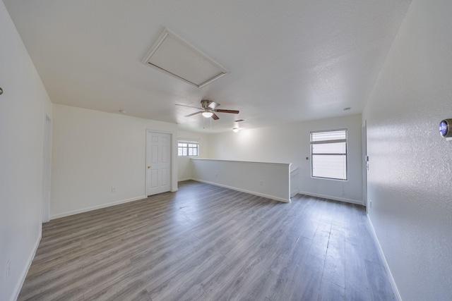 19314 Cactus Thorn Dr, Cypress, TX 77433 - unfurnished living room with baseboards, wood finished floors, and attic access