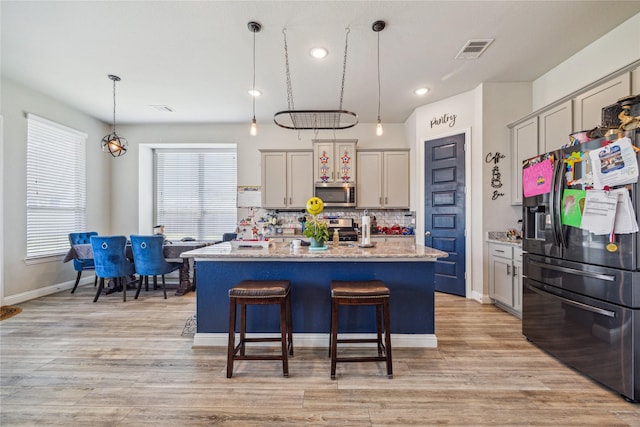 12402 Oakleaf Bend Dr, Humble, TX 77346 - kitchen featuring stainless steel appliances, tasteful backsplash, pendant lighting, a center island with sink, and plenty of natural light
