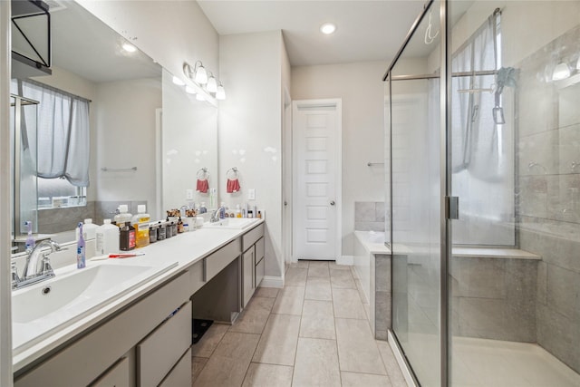 12402 Oakleaf Bend Dr, Humble, TX 77346 - bathroom with a shower stall, a garden tub, double vanity, recessed lighting, and tile patterned floors