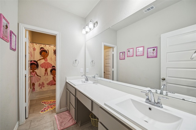 12402 Oakleaf Bend Dr, Humble, TX 77346 - full bathroom with double vanity, tile patterned flooring, and baseboards