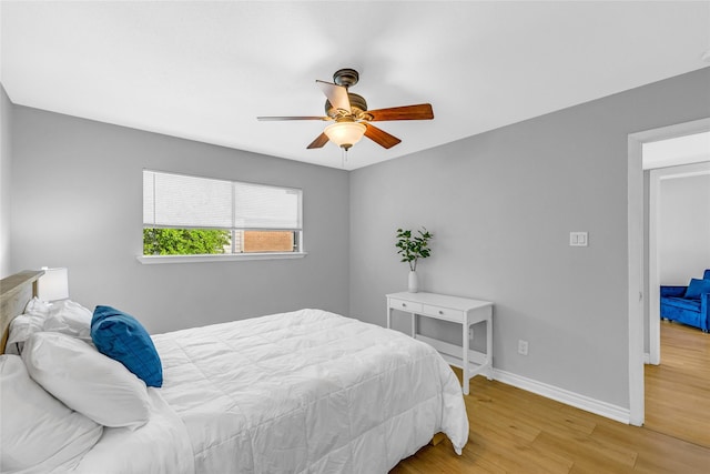 3220 69th St Unit K6, Galveston, TX 77551 - bedroom featuring wood finished floors, baseboards, and ceiling fan