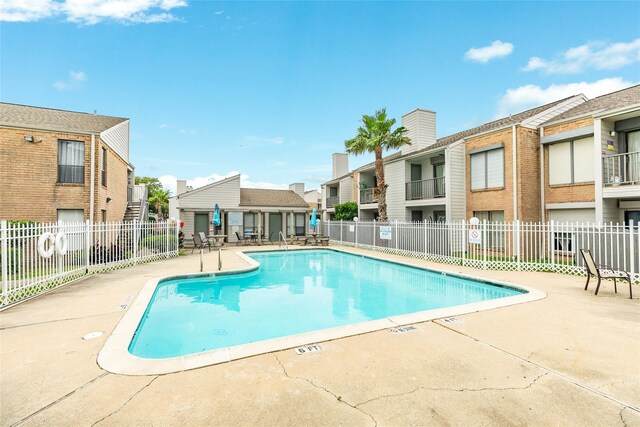 3220 69th St Unit K6, Galveston, TX 77551 - community pool featuring a patio, fence, and a residential view