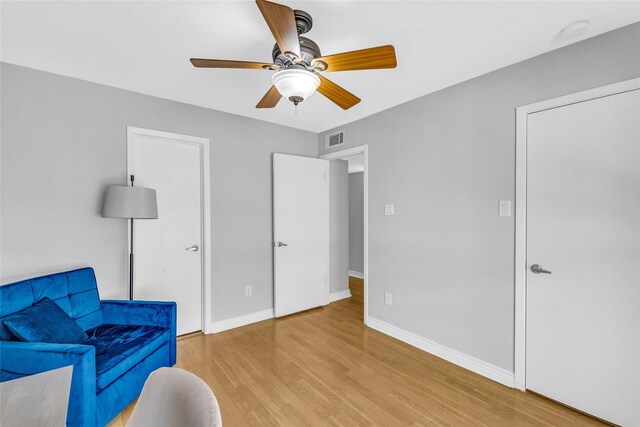 3220 69th St Unit K6, Galveston, TX 77551 - living area featuring light wood-style flooring, a ceiling fan, and baseboards