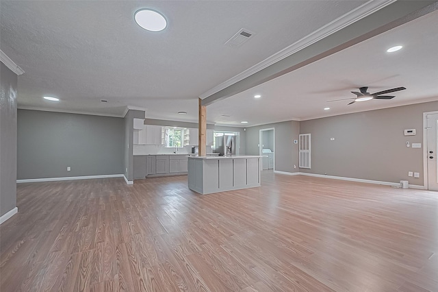 11903 Atwell Dr, Houston, TX 77035 - unfurnished living room with crown molding, baseboards, light wood finished floors, a ceiling fan, and recessed lighting